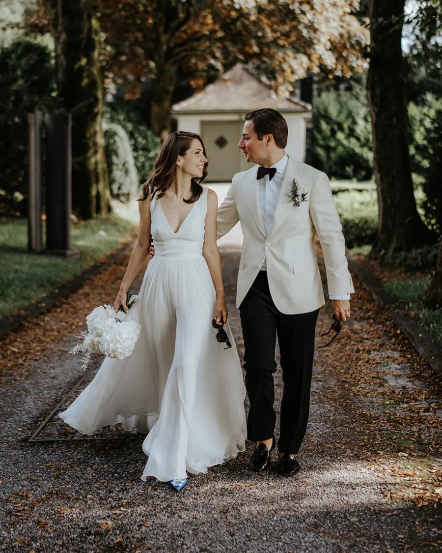 A couple walking down a garden path after their wedding