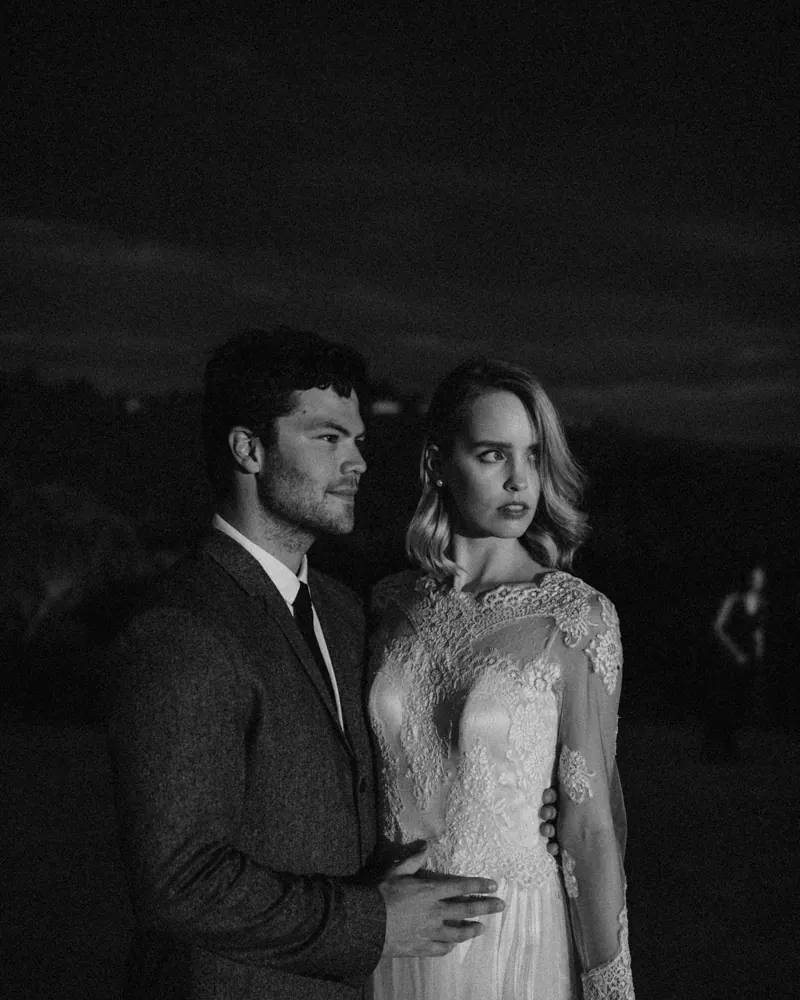 A bride and groom at dusk, photographed in low evening light